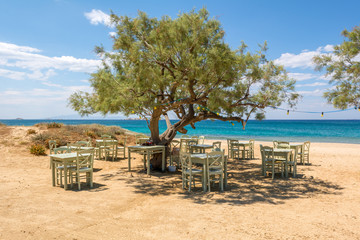 Romantic greek tavern on the Plaka beach. Naxos island, Greece. - obrazy, fototapety, plakaty