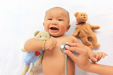Closeup of doctor hand holding stethoscope to checking newborn baby, medicine concept