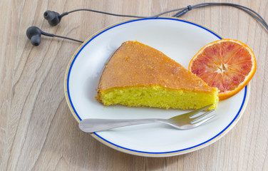 Cake, Homemade cakes with orange fruit and headphone on wood table background Concept relaxing in your free time.