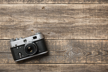 Retro film camera on wooden background