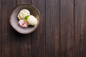 Assorted ice cream scoops in bowl top view