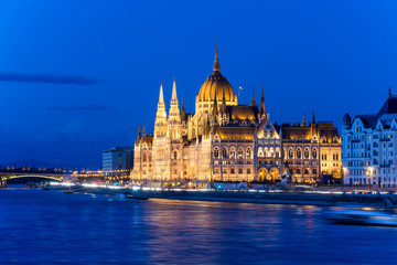 Famous Budapest parliament at the river Danube during blue hour from the side