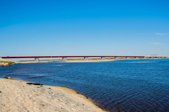 Nadym bridge and rainbow. The bridge over the river Nadym. North latitudinal way.