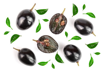 Dark grapes decorated with green leaves isolated on white background, top view. Flat lay