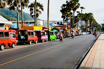 Street trading, tuk-tuk and rent scooters on the srteet  in Phuket. Thailand. - obrazy, fototapety, plakaty