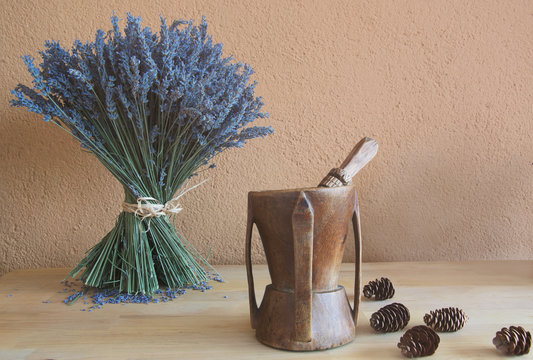 Old Vintage Wooden Mortar And Dried Lavender And Dried Pineapple On Wood Background