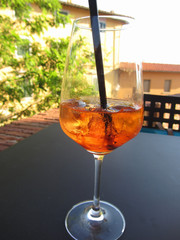 Summer refreshing aperitif drink on the rocks . Spritz cocktail with lemon slice