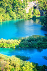 Panoramic view of waterfalls, rocks and lakes from popular tourist viewpoint in Plitvice Lakes National park. Amazing nature summer landscape, famous landmark in Croatia, vertical image