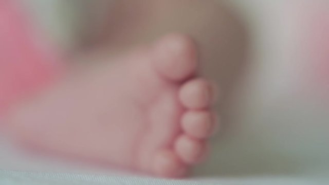 newborn baby sleeping in crib foot close up