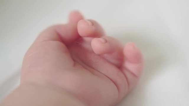 newborn baby sleeping in crib hand close up