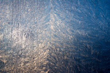 Fototapeta na wymiar Winter patterns on windows glass.
