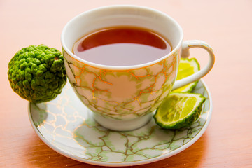 Hot tea with bergamot on wooden table in the cold. Winter.