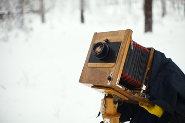 The photographer photographs the old camera on a large format.