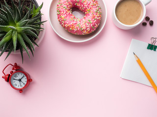 Flat lay Coffee Cup Donut Cactus Notepad Pencil Watch Player Vanilla on a Pink background