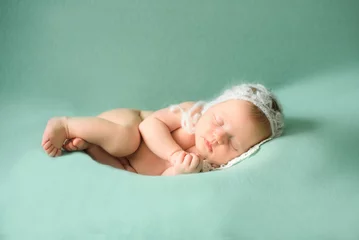 Fototapeten Stock photo of beautiful newborn baby sleeping in cute props © Nestyda