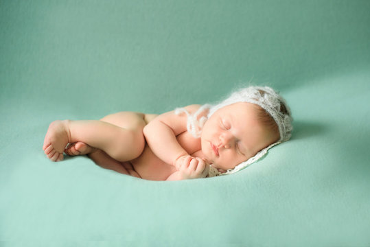 Stock photo of beautiful newborn baby sleeping in cute props