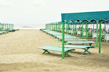 Daylight view to vibrant green and blue sunchairs