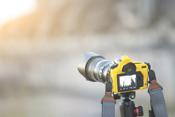 selective focus of camera liveview on tripod of taking monk statue