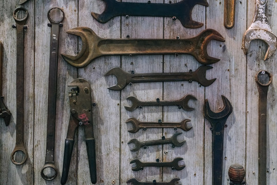 Image of variety of handy tools. Set of tools on wood panel background. Many rusty grunge wrench tools and variety tools on wood panel for car and motorbike fix diy concept.