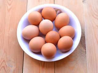 Bowl of eggs on the wooden background