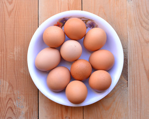 Bowl of eggs on the wooden background