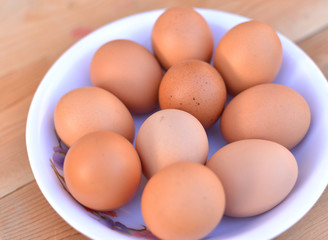 Bowl of eggs on the wooden background