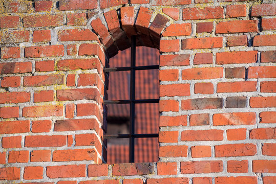 Medieval window in a brick wall. Malbork, Poland
