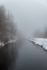 Obraz na płótnie Canvas mist over a narrow channel in Nykroppa sweden