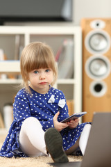 Cute little girl on floor carpet use cellphone