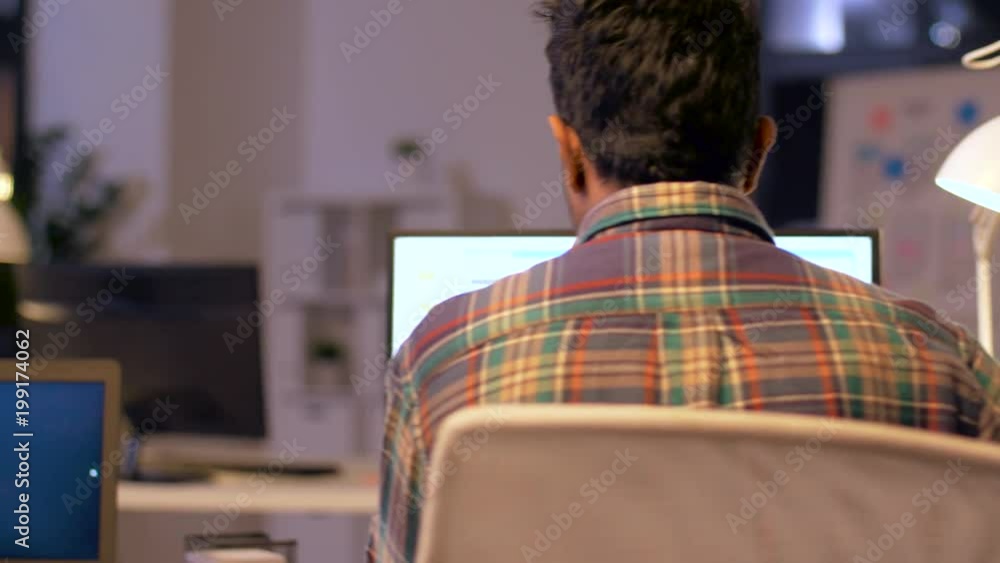 Poster deadline, technology and people concept - programmers with computers working together late at night 