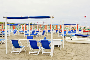 Daylight view to vibrant blue sunchairs and sunshades