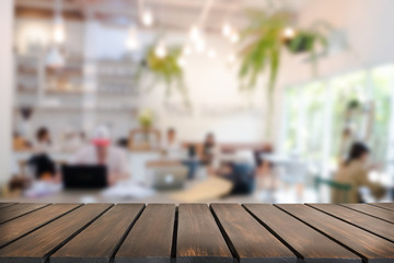 Empty wooden table space platform and blurred resturant or coffee shop background for product display montage