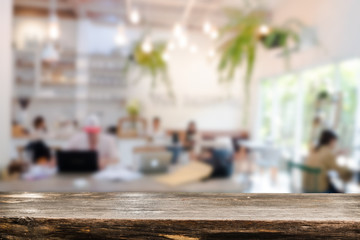 Empty wooden table space platform and blurred resturant or coffee shop background for product display montage