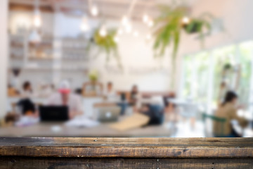 Empty wooden table space platform and blurred resturant or coffee shop background for product display montage