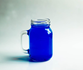 Blue water jug ​​on a white backdrop.