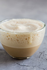 Cup of coffee steamed with cream