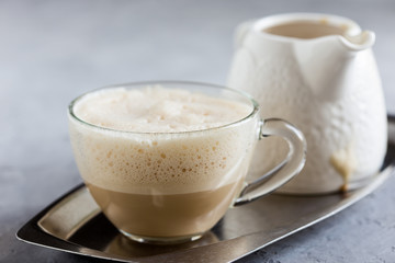 Cup of coffee steamed with cream