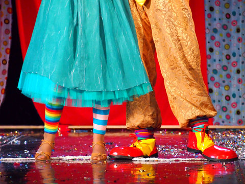 Dancing couple of clowns on stage