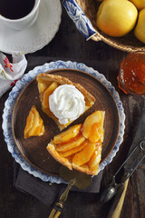 French cuisine: apple tart with whipped cream and cup of coffee for sweet coffee break