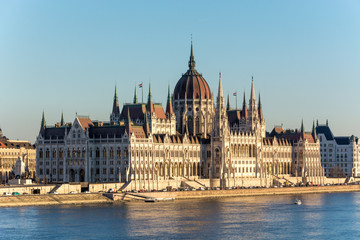 Fototapeta na wymiar Famous Budapest parliament at the river Danube during sunset from the side