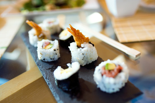 Sushi and chopsticks. Food detail concept.
