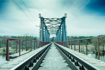 Fototapeta na wymiar Railway metal bridge, toned photo