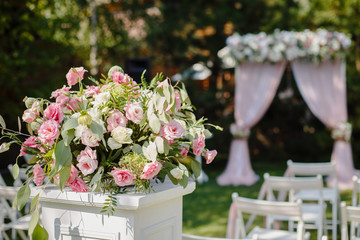 Wedding ceremony in beautiful garden. Elegant decoration of wedding ceremony in pretty pink colors....