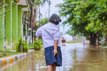 happy girl walking to flood in school