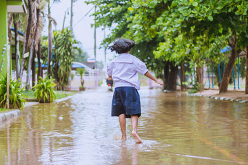 happy girl walking to flood in school