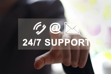Businessman pressing button 24 hours support service on technology panel.