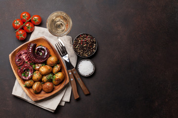 Grilled octopus with small potatoes and wine © evgeeenius