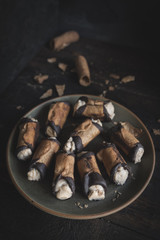 Served traditional Italian dessert cannoli with pistachios cream