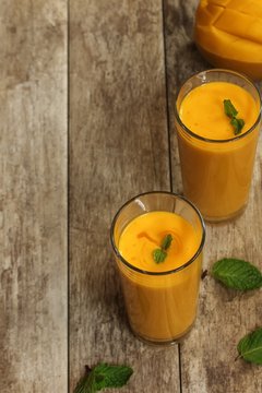 Homemade Mago Lassi / Smoothie with minte leaf garnish, selective focus