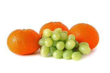Ripe fresh orange mandarins & grapes. Detox diet food & healthy lifestyle concept: An aromatic colorful tasty delicious sweet fruits. Vegetarian concept, organic vitamins.